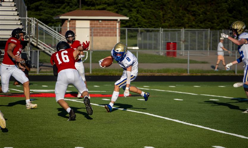 A football player runs the ball